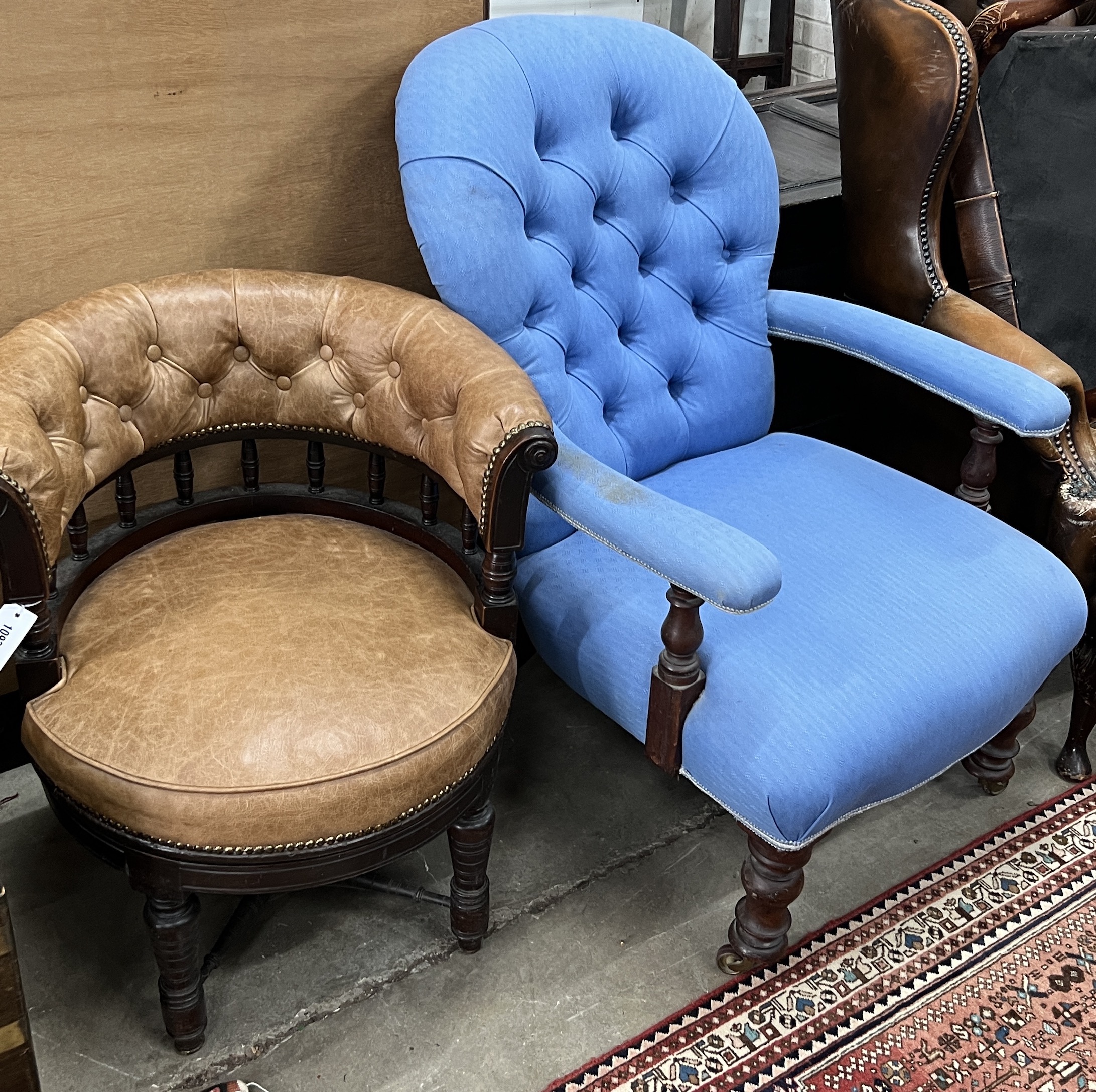 A late Victorian mahogany buttoned brown leather swivel desk chair, width 64cm, depth 56cm, height 74cm, together with a Victorian spoonback open armchair
